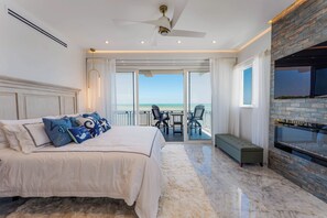 Luxurious bedroom with a comfortable bed, ocean views, and direct balcony access