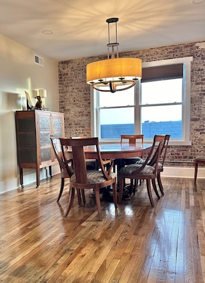 Dining table and 6 chairs just off the full kitchen, antiques and art abound.