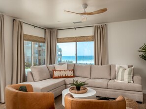 Relax in the spacious living room with panoramic ocean views.