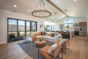 Large, open concept main floor with living room, double island kitchen, dining room and coffee/wine bar