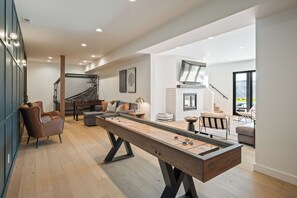 Game room equipped with shuffle board, foosball and pop-a-shot