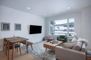 The great room is great for hanging out with friends and family. 

Enjoy a movie or catch the game on a brand new 65" Samsung QLED smart TV.