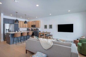 The great room is great for hanging out with friends and family. 

Enjoy a movie or catch the game on a brand new 65" Samsung QLED smart TV.