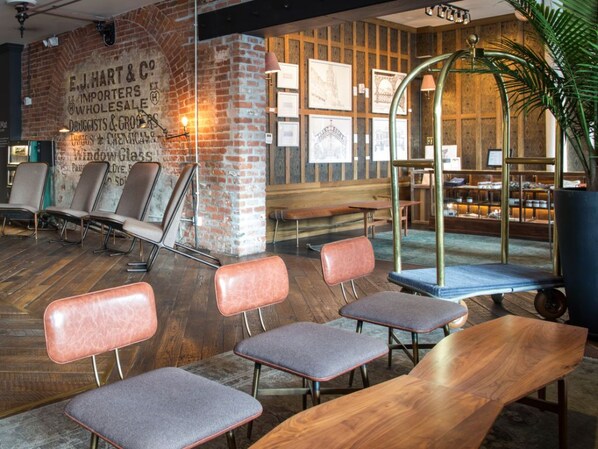 Lobby with cozy seating nooks and exposed brick for a welcoming feel