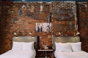 Rustic brick wall backdrop with elegant white armchairs for a relaxing read