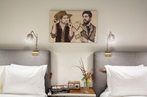 Inviting bedroom haven featuring unique artwork and fresh greenery