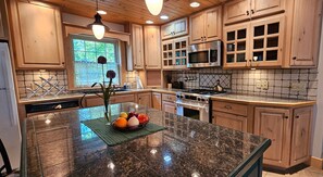 Cook your favorite meals in this spacious kitchen featuring modern appliances and plenty of counter space.