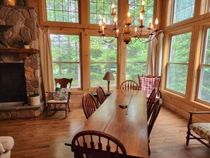 Enjoy family meals in this dining area with floor-to-ceiling windows and beautiful forest views.