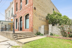Side of building & gated side yard with the original (restored) sign from 1897 
