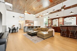 Living area: historic bar, kitchen, dining, and 120 inch Laser TV