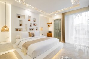 Bedroom designed with a king-size bed, smart TV, and attached bathroom.
