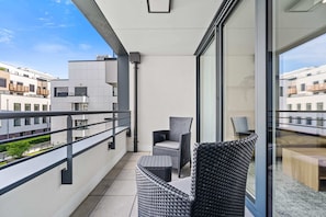 Spacious balcony with comfortable seating, an ideal spot to unwind and take in the vibrant surroundings