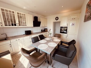Dining area with seating for 6 people: Stylish dining area with wooden table and seating for 6 people. (1)