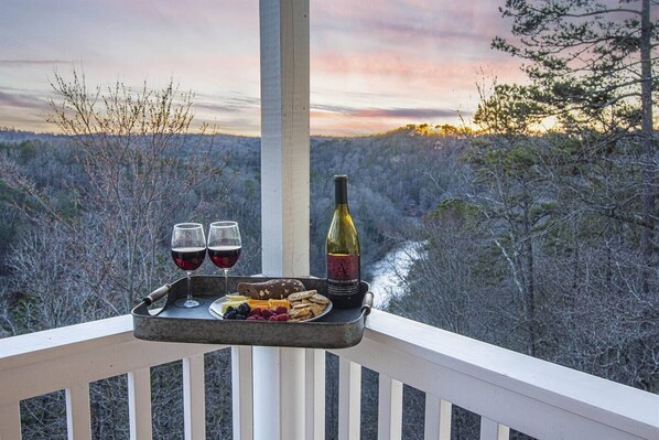 Balcony Bliss: Sip wine as sunset paints the sky over serene mountain and river views!