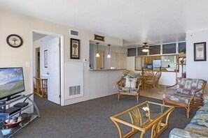 Spacious living area with central AC, smart TV with cable, and plenty of seating