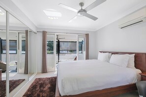  The light and airy second bedroom offers a king-size bed with both air-conditioning and a ceiling fan as well as access to the balcony. 
