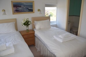 Twin bedroom with double aspect views of gardens and ensuite bathroom