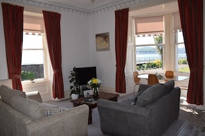 Scalpsie Bay livingroom and dining with large bay window & side window overlooking the sea. 