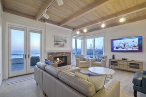 Living room windows provide views of the ocean. Smart TV, ideal for cozy movie nights or catching up on your favorite shows.