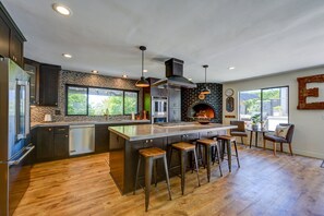 Fully stocked kitchen with a double convection oven, microwave, multiple appliances including blender and kitchenaid mixer along with a Keurig coffee maker with complimentary starter pack of coffee pods