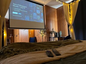 Relax in bed and watch your favorite movie or show on the projector.