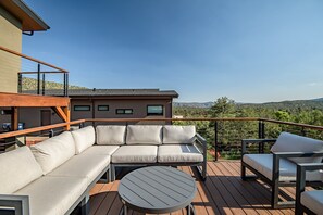 Private balcony with outdoor dining and seating and propane gas bbq