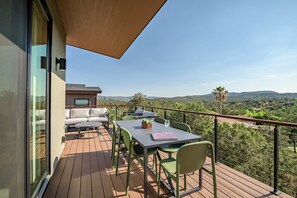 Private balcony with outdoor dining and seating and propane gas bbq