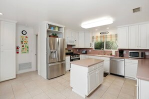 A spacious kitchen awaits your family to prepare and enjoy a meal!