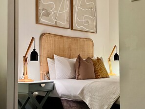 Relax and recharge in this Boho inspired aesthetic, featuring a comfortable bed, soft linens, and a touch of natural light.