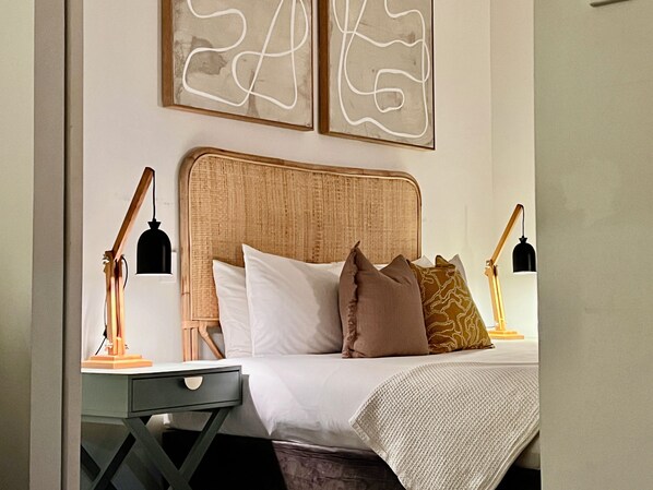 Relax and recharge in this Boho inspired aesthetic, featuring a comfortable bed, soft linens, and a touch of natural light.