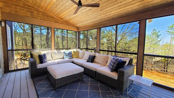 Large screen porch with lounge area and table