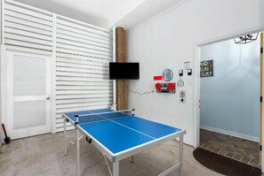 Ping pong, streaming TV, wall games, foosball, cornhole, and more. Garage/gameroom looking iinto house.
