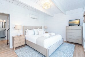 Primary Bedroom with King Sized bed and relaxing coastal chic decor