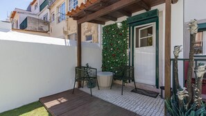 The small porch, adorned with cozy furniture and potted plants, provides a tranquil spot for morning coffee and evening relaxation #cozy #outside #portugal #pt #lisbon
