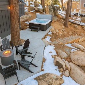 Hot tub and fire pit with lake view.