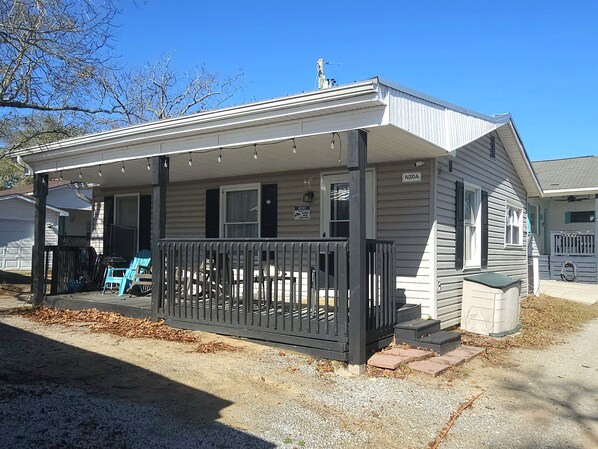 Exterior of House - porch with 3 chairs and 2 rocking chairs, sand toys, 4 beach chairs. It's the perfect spot to sip hot coffee and enjoy the morning breeze! 