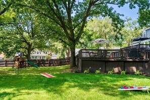 Backyard Paradise: Enjoy sunny days with yard games, a swing set, and a spacious deck for entertaining!