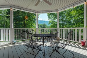 Dine al fresco on the covered, wraparound porch with bistro-style lighting overlooking beautiful mountain-top views!