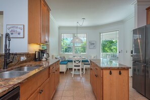 Kitchen with dishwasher, drip-style coffee pot, electric kettle, and breakfast nook