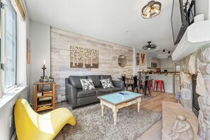 Living area offering sleeper sofa, gas fireplace, flat screen TV and plenty of cozy furniture.
