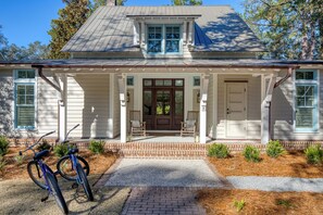 Close view of the home with 2 rockers outside to enjoy coffee or a cocktail!
