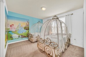 Step into a fairytale with this magical princess-themed bedroom, featuring two charming twin beds designed like royal carriages.