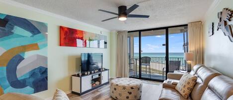 Comfortable sectional couch, fun art decor, and balcony to the best view of the Gulf!
