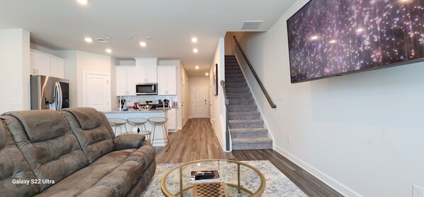 The living room relax with reclining seats and a 65’in smart tv that can swivel 