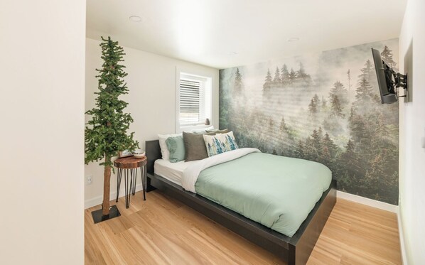 Drift off in this serene bedroom with a comfortable memory foam hybrid mattress, a streaming TV for your enjoyment, and a lighted pine tree for ambiance. A makeup mirror, hairdryer, and full-length mirror are available