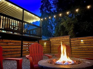 Gather under the trees at our private outdoor firepit, surrounded by forest and glowing with string lights—perfect for s’mores, stories, and starry nights.