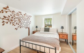The Tree Room: Enjoy a restful sleep on the comfortable memory foam hybrid mattress, complete with dual nightstands and a streaming TV. A makeup mirror, hairdryer, and full-length mirror are also provided