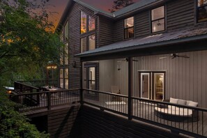 You'll love the expansive wrap-around covered deck-picturesque views from Master Suite 1 to the dining area & glow putt. Follow the open boardwalk to the left to find a stairway leading to the private hot tub area, perfect for relaxing in serenity