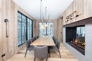 The home`s pass through fireplace connects the dining room and living room.