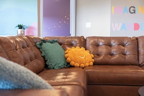 Upstairs living room holds a 75" TV with a Nintendo Switch.
